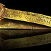 A folded strip of gold, with a Biblical inscription